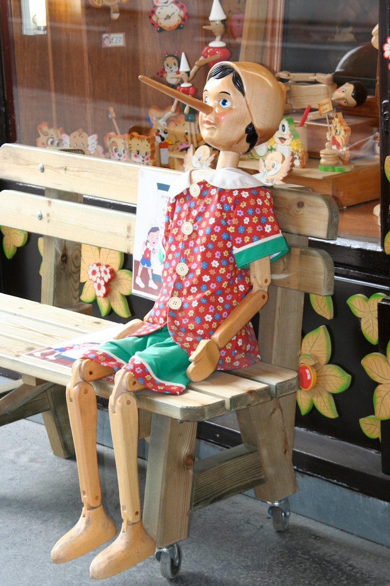 Pinocchio statue on wooden bench