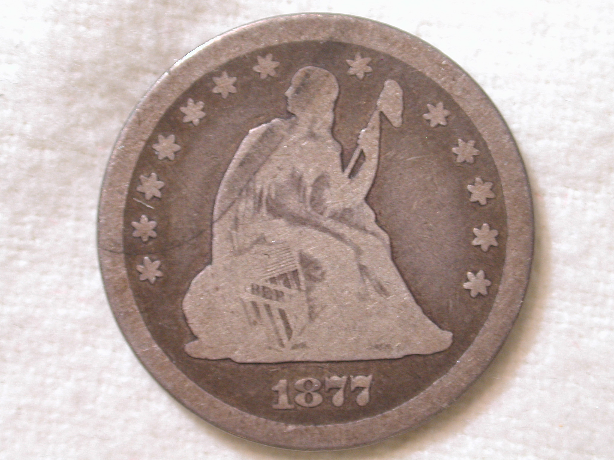 1877-CC U.S. Liberty Seated Quarter Very Good