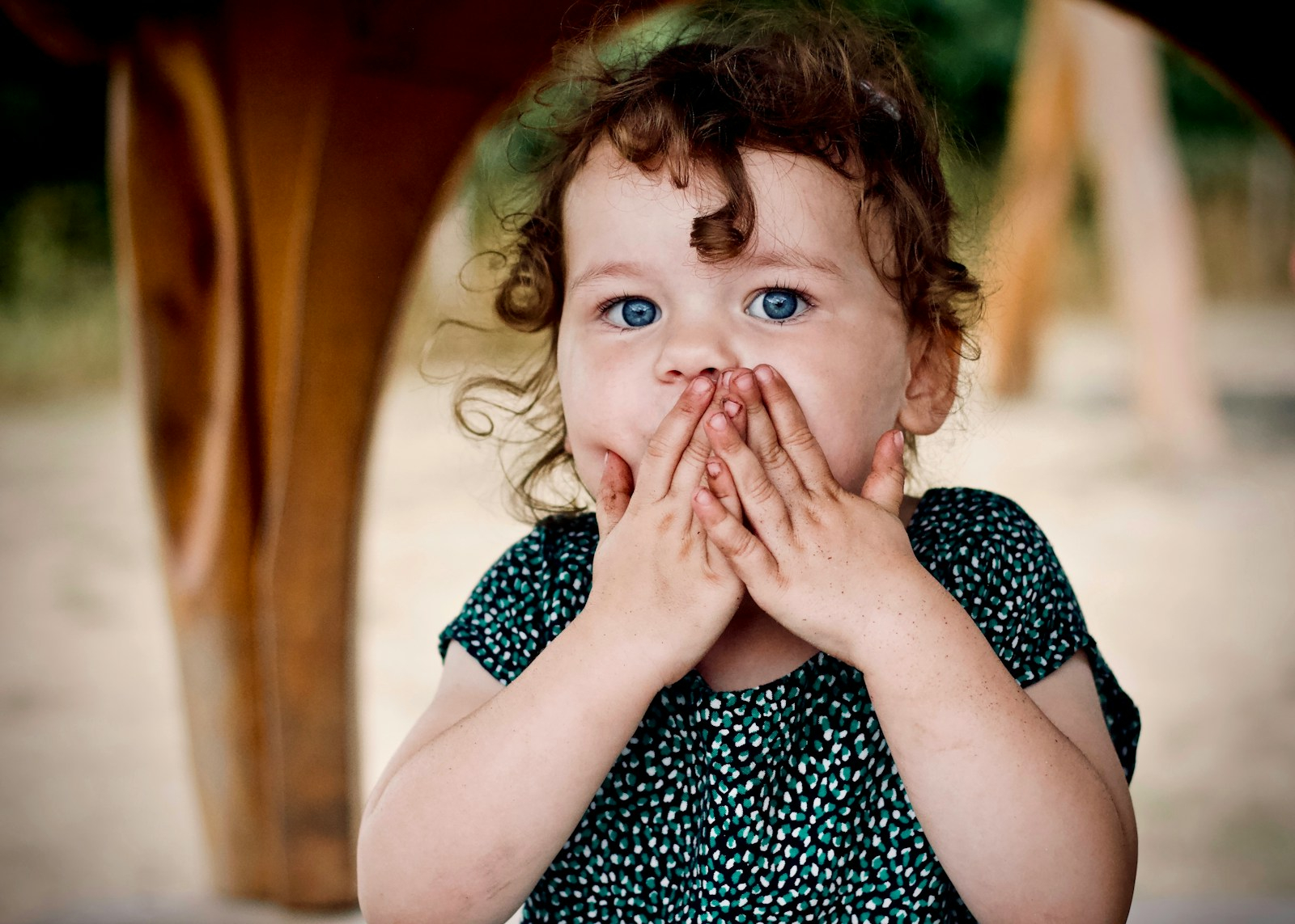 toddler holding her lips